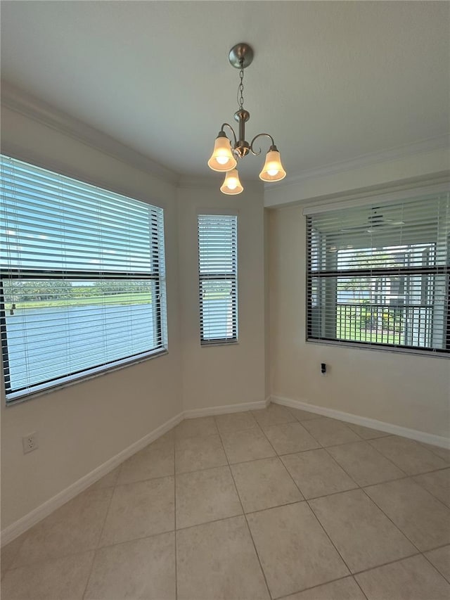 7005 River Hammock Dr Unit 207, Bradenton, FL 34212 - empty room featuring a chandelier, crown molding, and light tile patterned floors
