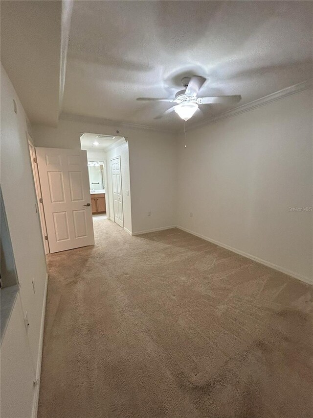 7005 River Hammock Dr Unit 207, Bradenton, FL 34212 - unfurnished room with light colored carpet, ceiling fan, crown molding, and a textured ceiling