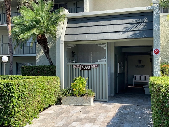 doorway to property with stucco siding