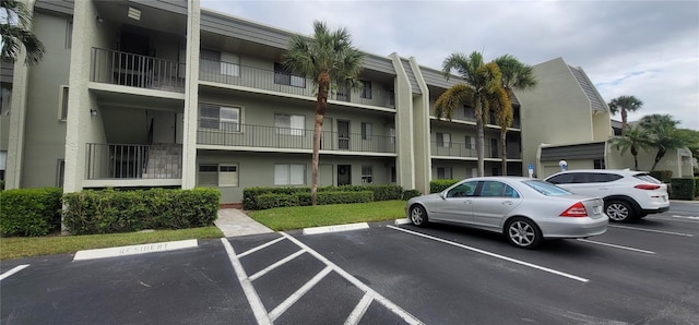 view of building exterior with uncovered parking