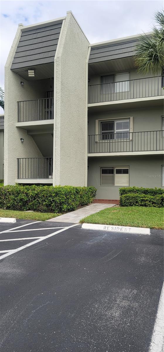 view of building exterior featuring uncovered parking