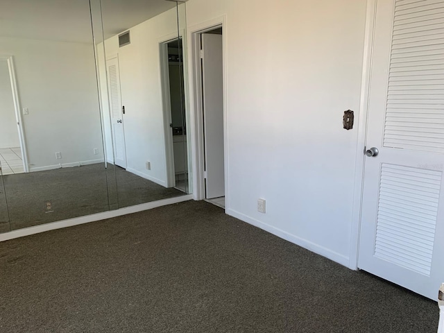 unfurnished bedroom featuring carpet floors, baseboards, and visible vents