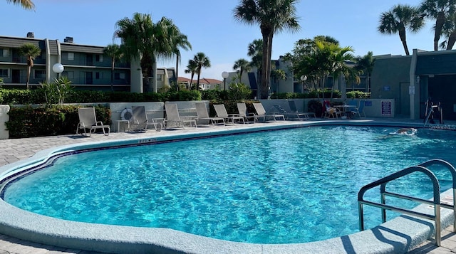 pool featuring a patio area and fence