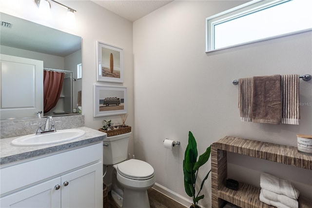 3390 Melissa Ln, The Villages, FL 32163 - bathroom with toilet, curtained shower, vanity, baseboards, and visible vents