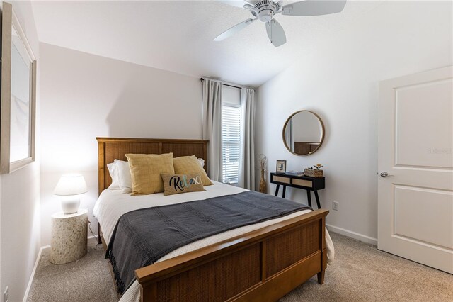 3390 Melissa Ln, The Villages, FL 32163 - bedroom with vaulted ceiling, baseboards, light colored carpet, and ceiling fan