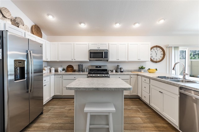 3390 Melissa Ln, The Villages, FL 32163 - kitchen featuring light countertops, dark wood-style floors, a sink, and appliances with stainless steel finishes