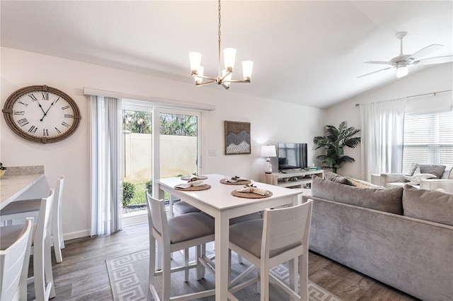 3390 Melissa Ln, The Villages, FL 32163 - dining space featuring ceiling fan with notable chandelier, lofted ceiling, and wood finished floors