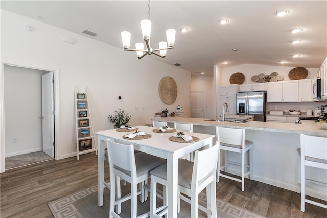 3390 Melissa Ln, The Villages, FL 32163 - kitchen with visible vents, a chandelier, stainless steel appliances, a sink, and vaulted ceiling