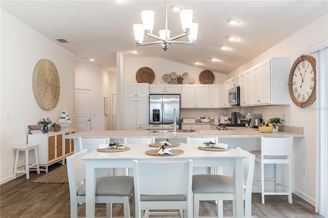 3390 Melissa Ln, The Villages, FL 32163 - kitchen featuring light countertops, a peninsula, appliances with stainless steel finishes, and vaulted ceiling