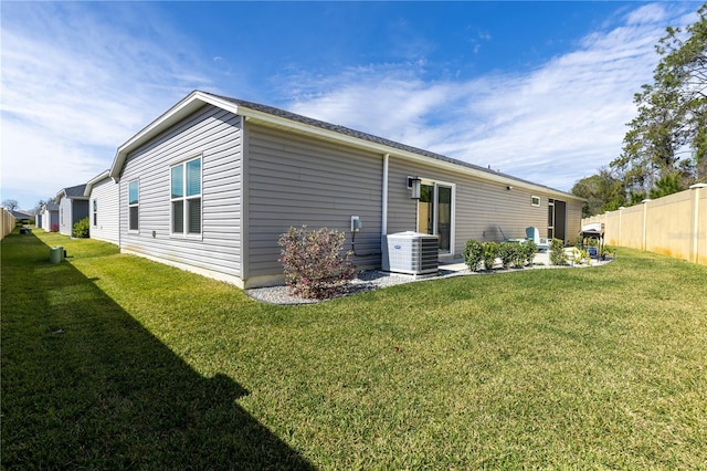 3390 Melissa Ln, The Villages, FL 32163 - rear view of property featuring a patio, central air condition unit, fence, and a lawn