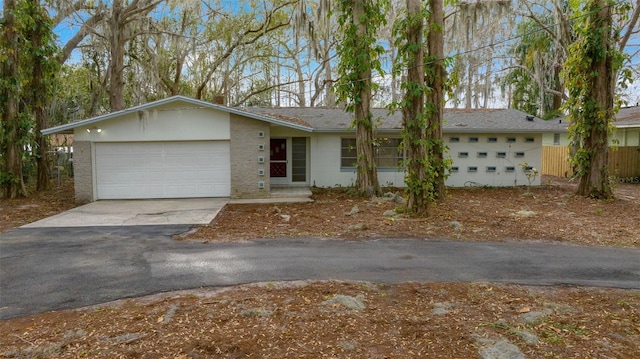 single story home featuring driveway and an attached garage