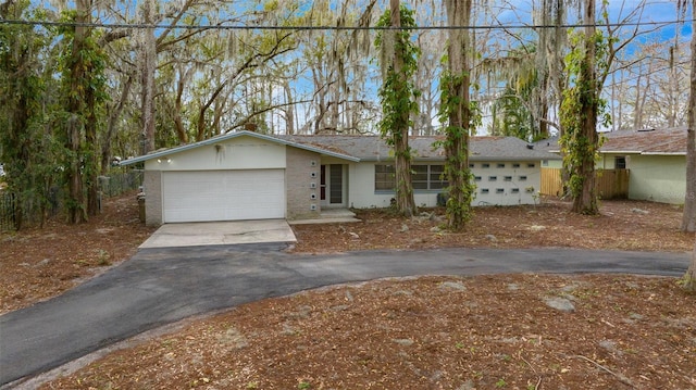 single story home featuring driveway and an attached garage