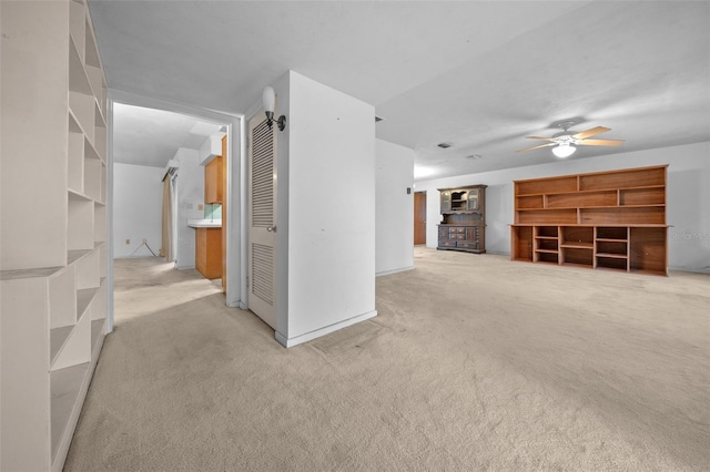 unfurnished living room with light carpet and ceiling fan