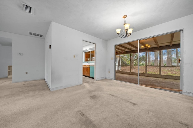 empty room featuring light carpet, visible vents, and a chandelier