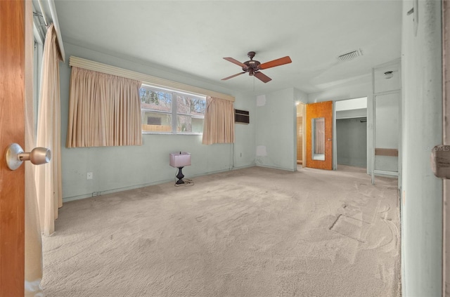 empty room featuring light colored carpet, ceiling fan, and visible vents