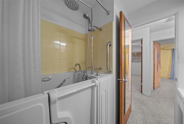 bathroom with visible vents and shower / bath combo with shower curtain