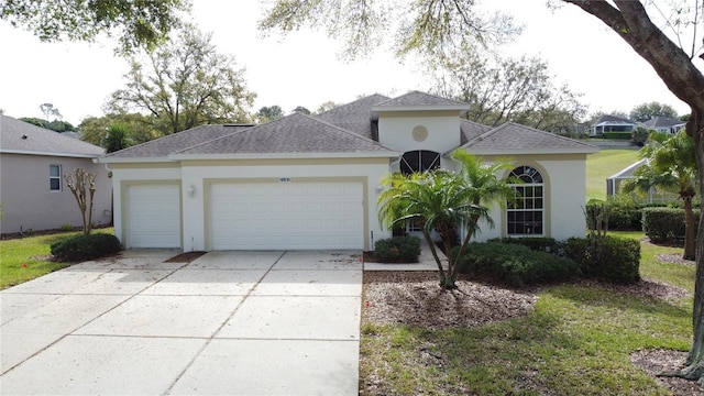 view of front of property with a garage, concrete driveway, roof with shingles, and stucco siding