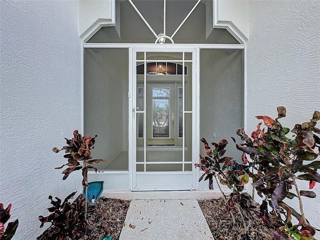 property entrance with stucco siding