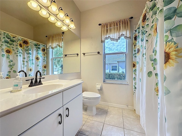 full bathroom featuring tile patterned flooring, baseboards, vanity, and toilet