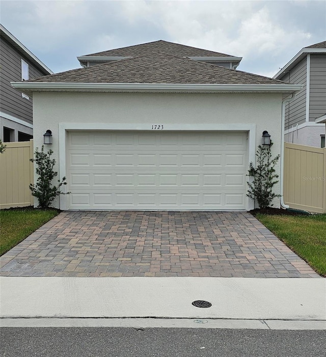 1723 Happiness Row, Kissimmee, FL 34744 - garage featuring decorative driveway and fence