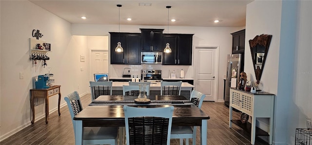 1723 Happiness Row, Kissimmee, FL 34744 - dining area with recessed lighting, dark wood finished floors, visible vents, and baseboards