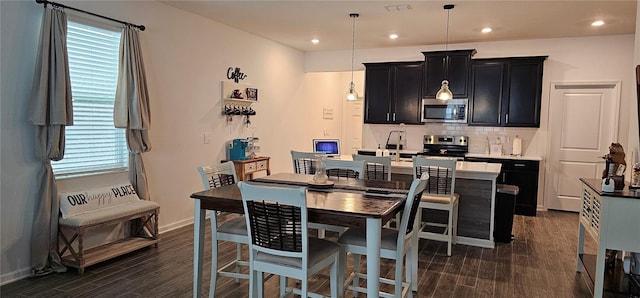 1723 Happiness Row, Kissimmee, FL 34744 - dining area with dark wood-type flooring, recessed lighting, visible vents, and baseboards