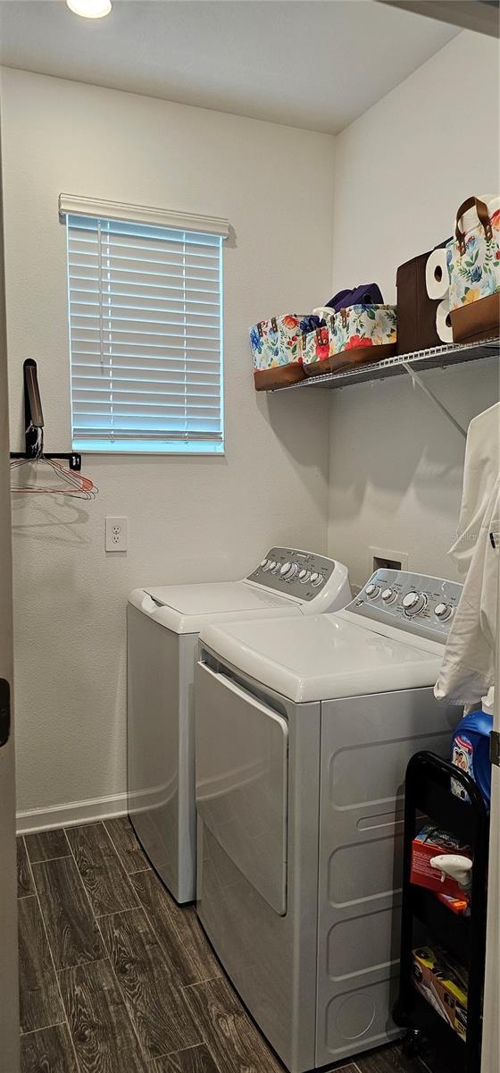 1723 Happiness Row, Kissimmee, FL 34744 - clothes washing area featuring dark wood-style floors, laundry area, independent washer and dryer, and baseboards