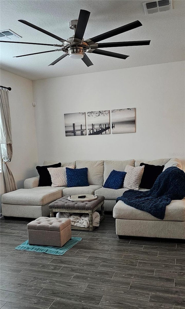 1723 Happiness Row, Kissimmee, FL 34744 - living area featuring a textured ceiling, dark wood-style flooring, and visible vents