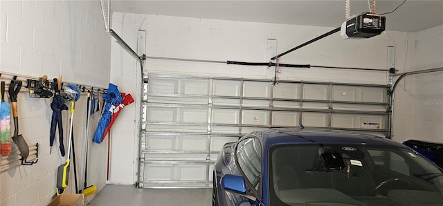 1723 Happiness Row, Kissimmee, FL 34744 - garage with a garage door opener and concrete block wall