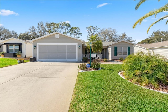 ranch-style home with driveway, a front lawn, and an attached garage