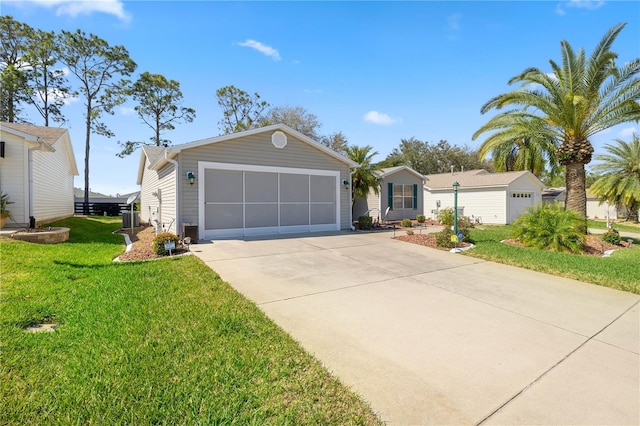 ranch-style home featuring a garage, driveway, and a front yard