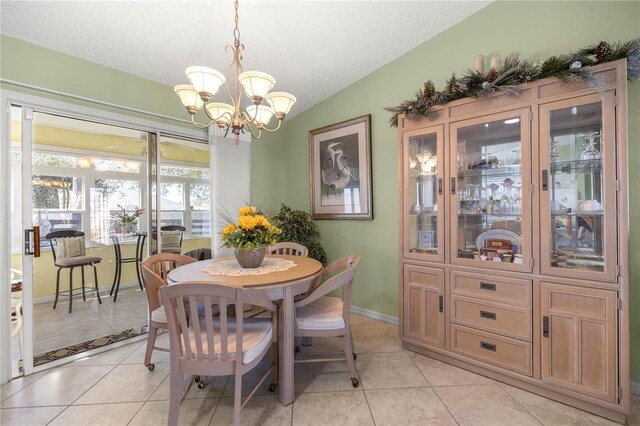 2738 Privada Dr, The Villages, FL 32162 - dining area with lofted ceiling, a textured ceiling, and light tile patterned flooring