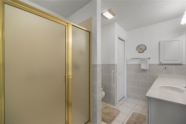 2738 Privada Dr, The Villages, FL 32162 - bathroom with a textured ceiling, tile patterned flooring, tile walls, and a shower stall