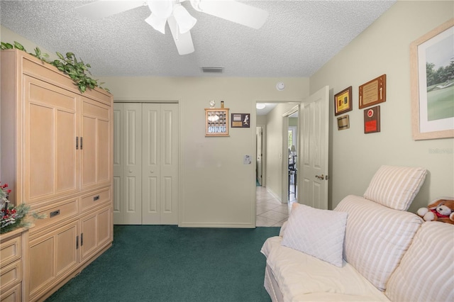 2738 Privada Dr, The Villages, FL 32162 - interior space featuring visible vents, dark carpet, a textured ceiling, and dark tile patterned flooring
