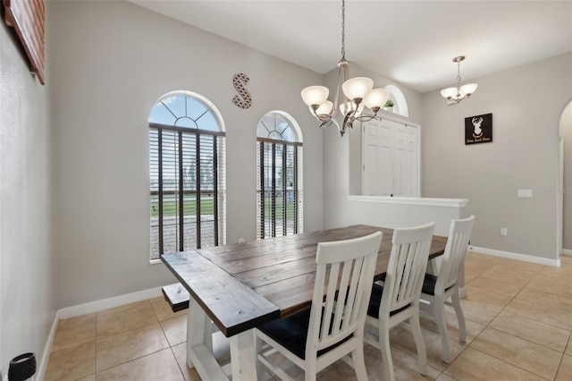 dining room with light tile patterned flooring, baseboards, and an inviting chandelier