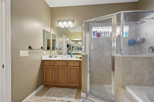 bathroom with a stall shower, tile patterned flooring, vanity, and tiled bath