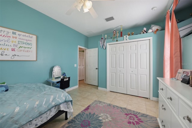 bedroom featuring light tile patterned floors, baseboards, visible vents, ceiling fan, and a closet