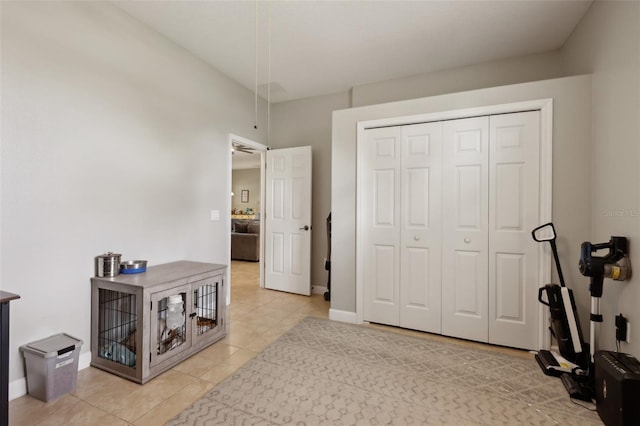 interior space with light tile patterned floors, baseboards, and a closet