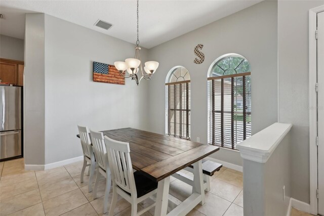 dining space with baseboards, visible vents, an inviting chandelier, and light tile patterned floors