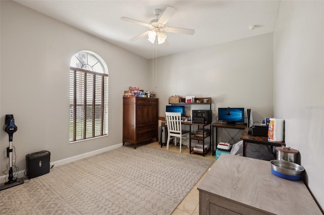 office area with ceiling fan and baseboards