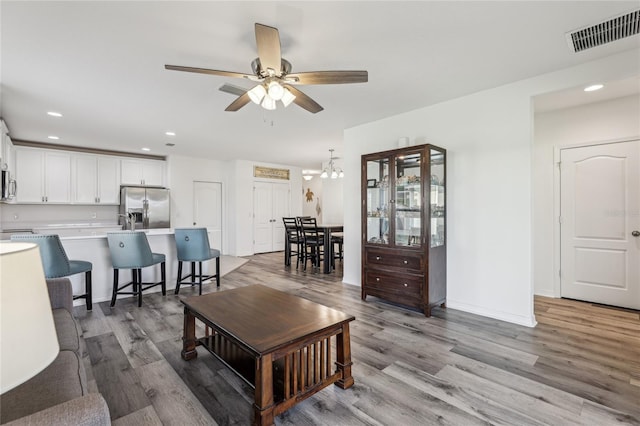 living room with recessed lighting, visible vents, light wood-style floors, and ceiling fan