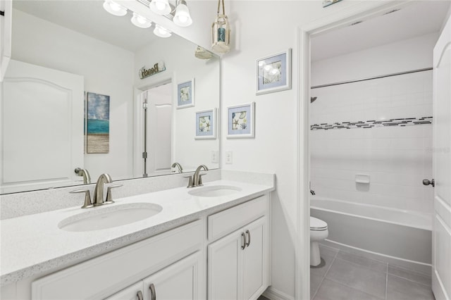 full bath featuring tile patterned flooring, double vanity, toilet, and a sink