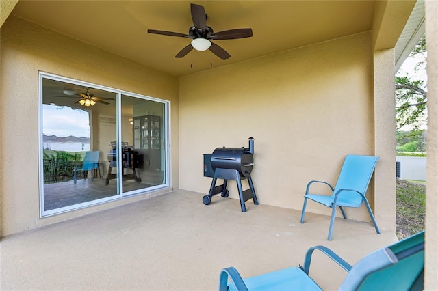 view of patio with area for grilling and a ceiling fan