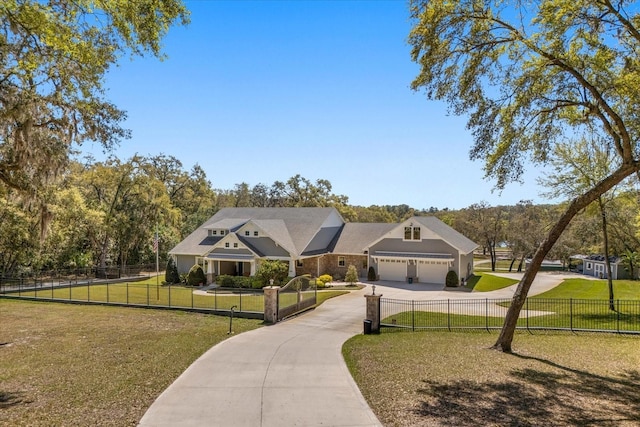 view of front of house featuring a garage, a front yard, concrete driveway, and a fenced front yard