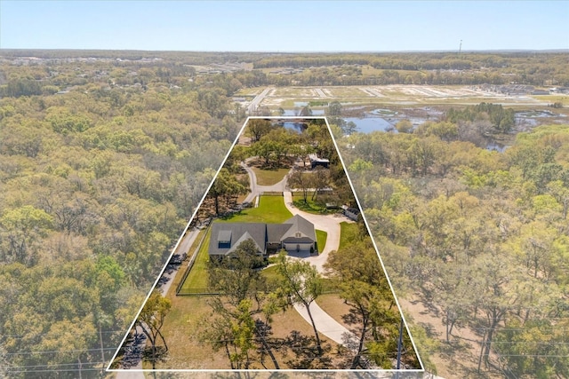 aerial view featuring a water view and a forest view
