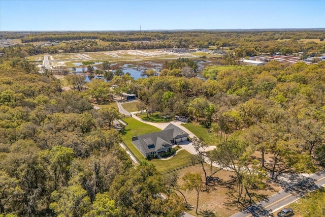 bird's eye view featuring a water view and a wooded view