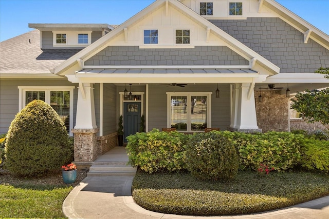 craftsman-style house featuring covered porch, a ceiling fan, a shingled roof, and board and batten siding
