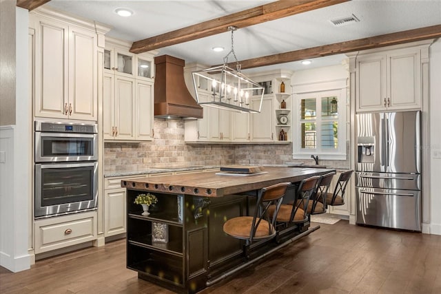 kitchen with open shelves, stainless steel appliances, wooden counters, visible vents, and custom exhaust hood