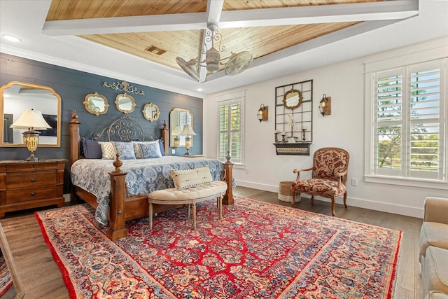 bedroom featuring baseboards, a raised ceiling, wood ceiling, visible vents, and wood finished floors