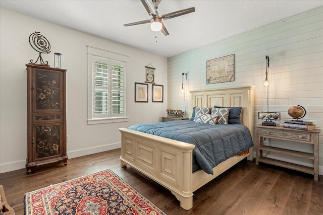 bedroom with baseboards, dark wood-style flooring, ceiling fan, and a textured ceiling
